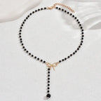 Midnight Bow Necklace – Black Beaded Y-Chain Pendant